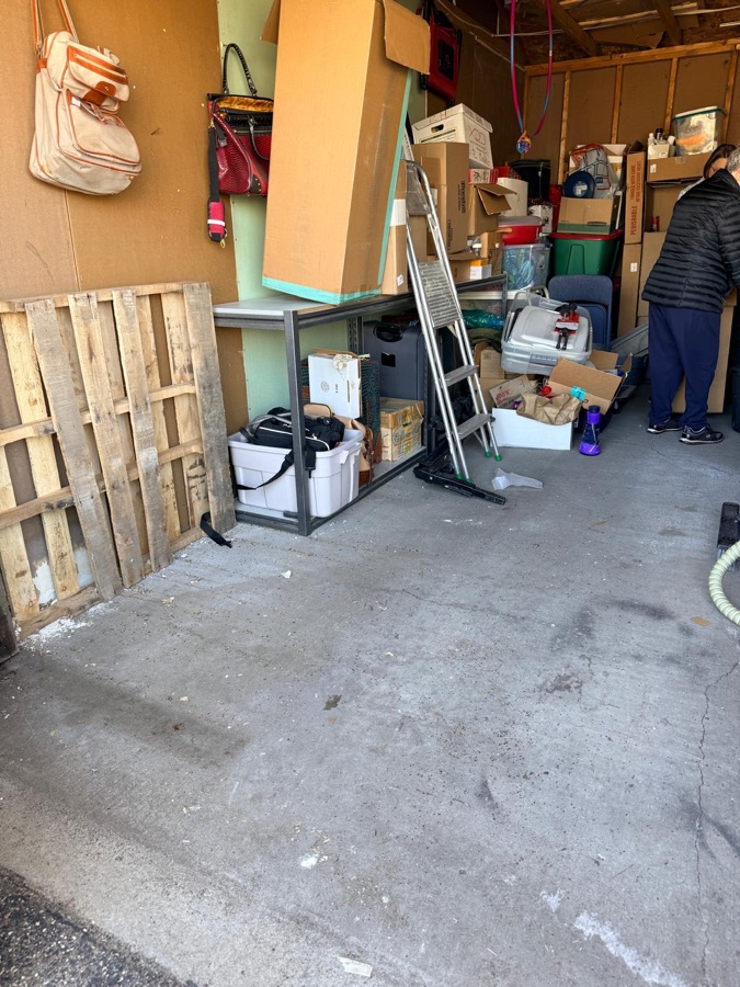 After: clean and organized garage shelving after junk removal