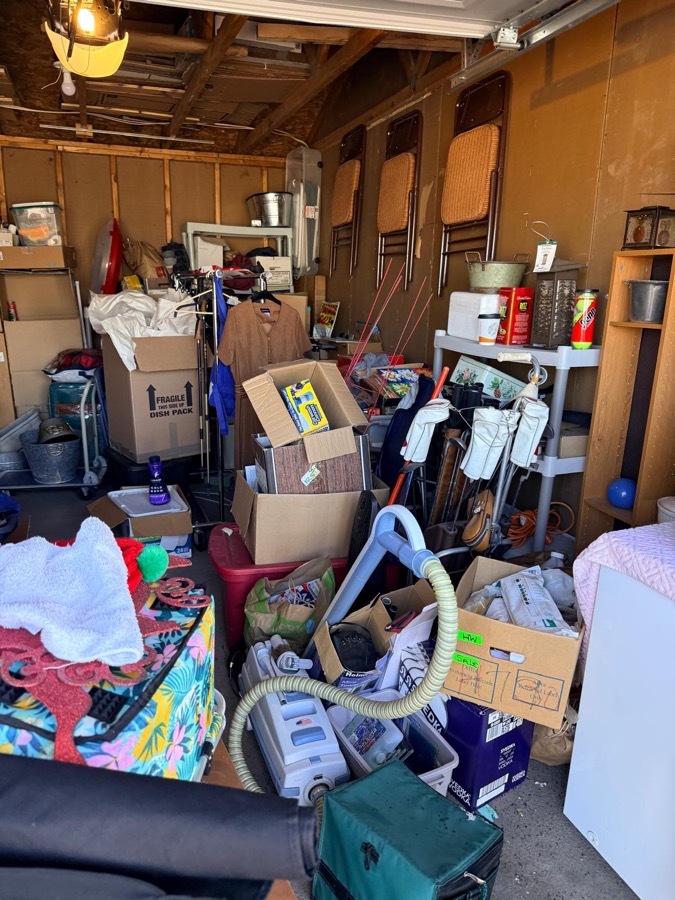 Before: cluttered garage packed with boxes and bags in Minneapolis home