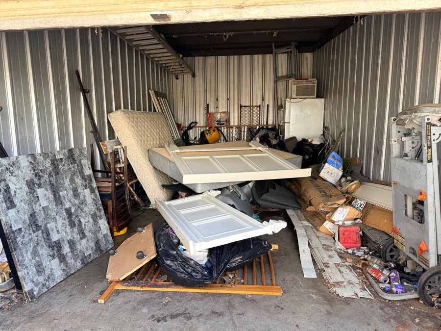 Before: storage unit full of old furniture and debris
